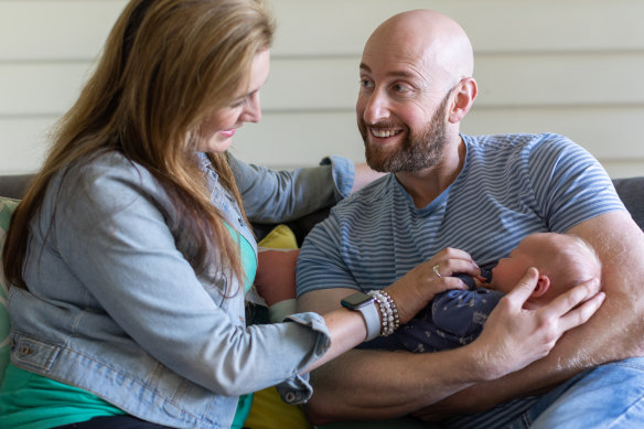 Mr Resnik with baby Eli and surrogate Carla Pincombe.