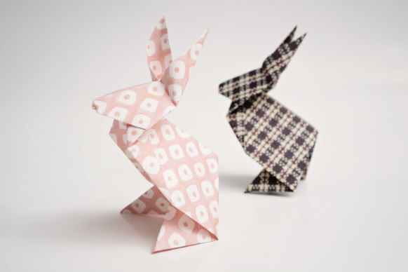 Origami bunnies make a quaint Easter decoration your guests can take home.