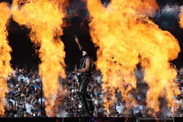 Paul Stanley is dwarfed by a wall of flames as KISS performs at the AFL grand final.