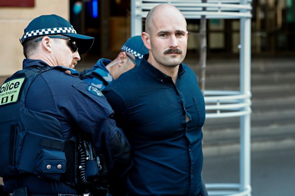 Thomas Sewell being arrested outside court on separate matters.