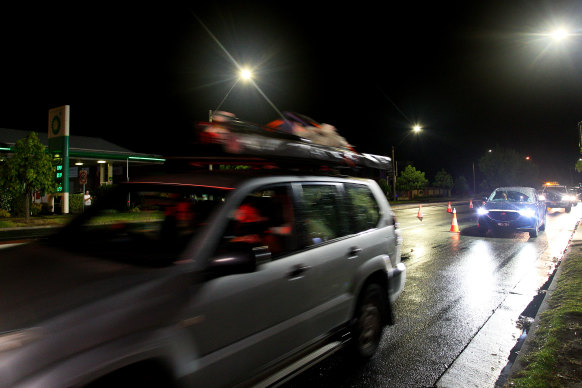 Cars cross the NSW-Victoria border after it reopened overnight.
