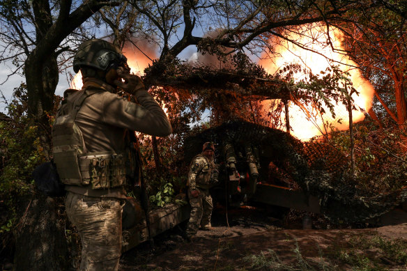 Ukrainians fire a D-20 howitzer at Russian troops from a position near Bakhmut in July.