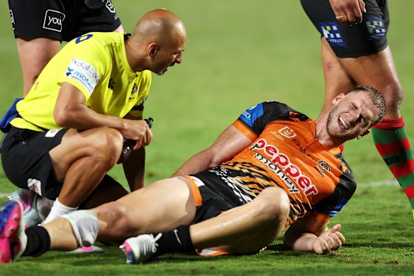 Wests Tigers Adam Doueihi suffers a hamstring injury against South Sydney in Gosford.