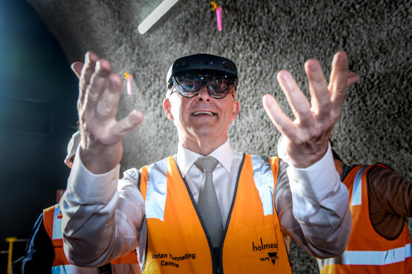 Albanese tries out some augmented reality glasses, used to simulate tunnelling equipment, during a tour today. 