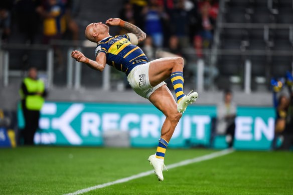 Flipping out: Blake Ferguson performs a back flip after scoring a spectacular try.