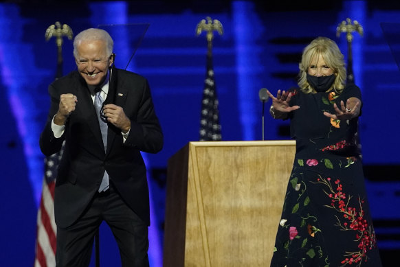 President-elect Joe Biden and wife Jill Biden gesture to supporters after claiming victory.