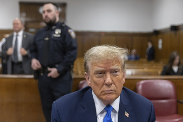 Former president Donald Trump awaits the start of proceedings on the third day of his trial.