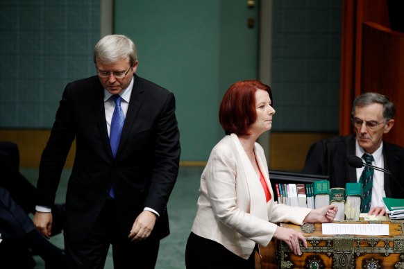 Foreign Minister Kevin Rudd passes then prime minister Julia Gillard, leading a minority government, in November 2010. 