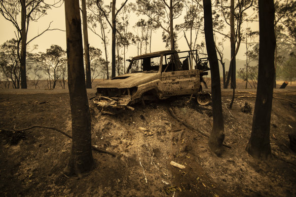 A National Parks and Wildlife Service LandCruiser lies burnt at Tallowa Dam Road in Kangaroo Valley. 