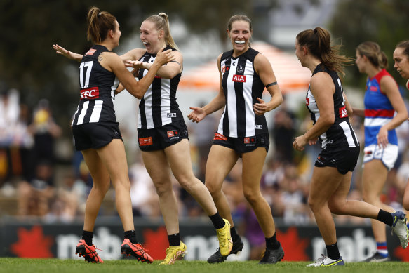 Collingwood celebrate after winning through to a semi-final against Adelaide.