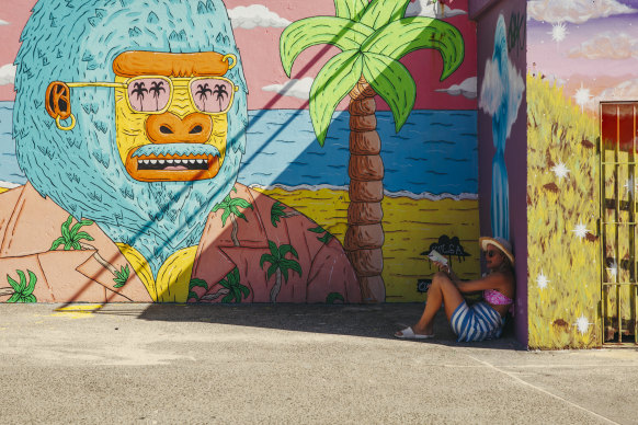 A Sydneysider shelters in the shade at Bondi on a hot day in January.
