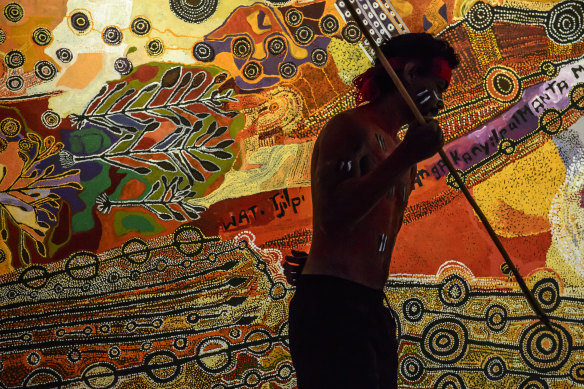 A dancer performs at the unveiling of a vast painting by artists from the Anangu Pitjantjatjara Yankunytjatjara (APY) lands in South Australia at the Australian War Memorial. 
