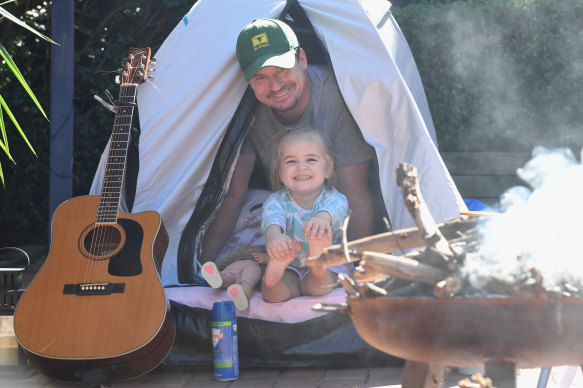 Martin Turner with his 3-year-old daughter camping in their backyard in the Sutherland Shire. 