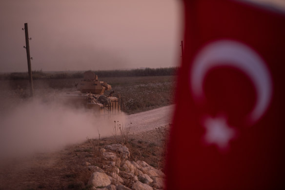 A Turkish armoured vehicle speeds towards the Syrian border near Akcakale.