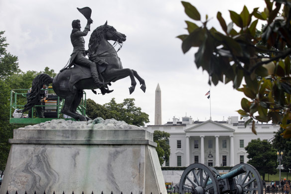 A worker cleans a statue of former US president Andrew Jackson near the White House. Protesters failed to bring it down on Monday.