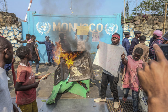A resident holds a placard reading “MONUSCO get out without delay” as they protest in Goma against the United Nations peacekeeping force (MONUSCO) deployed in the DRC.