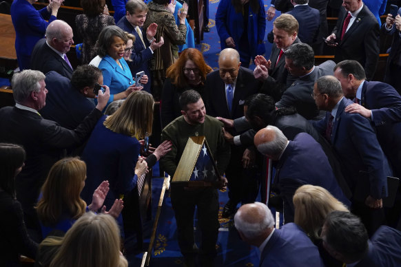 Ukrainian President Volodymyr Zelensky with an American flag given to him by House Speaker Nancy Pelosi.