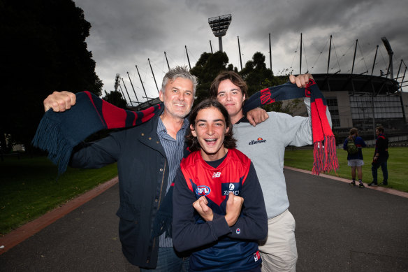 Melbourne supporters Nathan Wigmore with his two sons Max and Billy. 