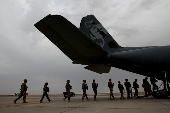 Australian troops board a C-130 aircraft departing Al Minhad Air Base for deployment to Afghanistan in 2013.