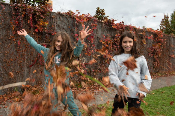 Evie and Zoe play in the garden on the last Sunday of autumn.