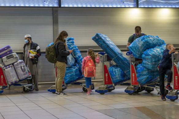 People line up to get on an overseas flight at the International Airport in Johannesburg.