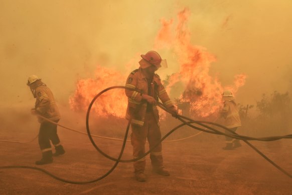 The NSW RFS crew from Kundle stood their ground against a fire sweeping towards them and homes at Hillville during the Black Summer bushfires in 2019.