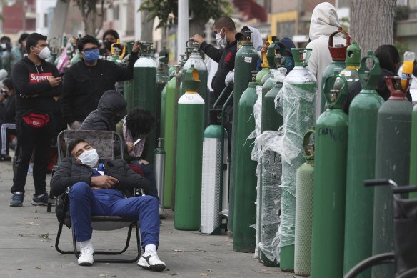 Peruvians wait in line, sometimes for up to 10 hours, to refill oxygen tanks in Callao.