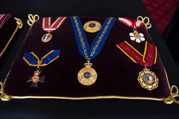 The insignia for Philip’s Knight of the Order of Australia rests on the centre of the cushion.