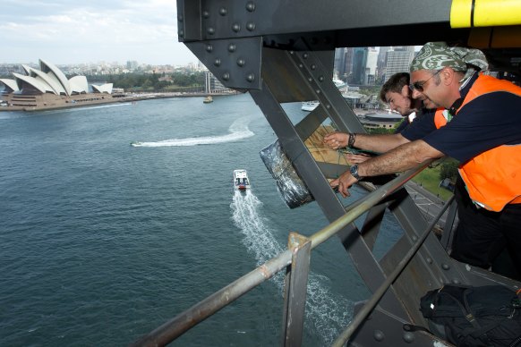 Fortunato Foti watches as fireworks are installed on the lower gantry of the Sydney Harbour Bridge on December 28, 2012.
