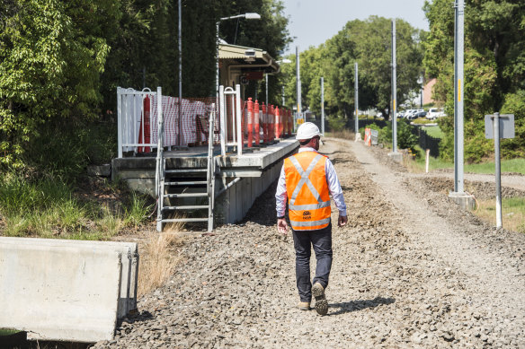 A contruction worker walks along the old Carlingford rail line, which has been torn up to make way for the light rail line.