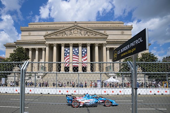 Scott McLaughlin (3) of New Zealand drives past the National Archives before the start of the race.