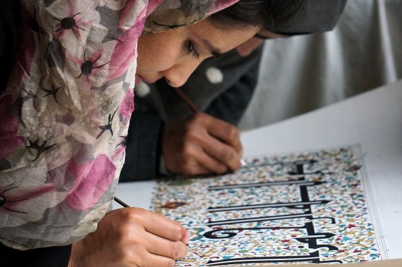 A woman at Kabul's Turquoise Mountain school practises her calligraphy.