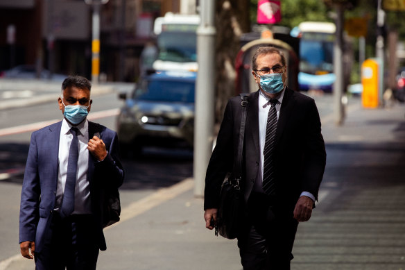 Michael Toohey, right, arrives at ICAC on Monday.