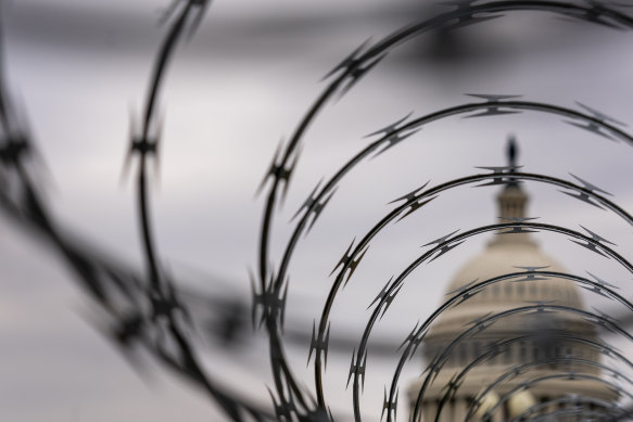 The wire-covered fencing that now protects the US Capitol in the wake of the January 6 riot. The impeachment hearing will decide if Donald Trump incited the violence.