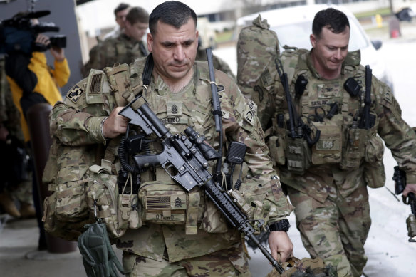 US soldiers prepare to board a bus at Fort Bragg military base.