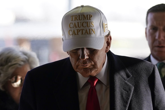 Donald Trump in a “Trump Caucus Captain” hat.
