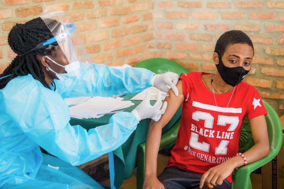 In Rwanda, a young man receives his first dose of vaccine in March.