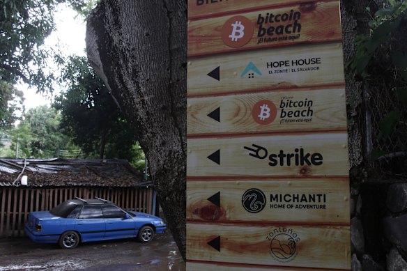 A sign advertising the acceptance of bitcoin at local businesses stands at one of the entrances to El Zonte.
