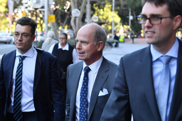 Former IOOF CEO Chris Kelaher (centre) leaves Federal Court.