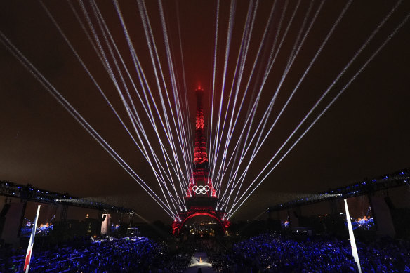 A light show is projected from the Eiffel Tower in Paris, France, during the opening ceremony of the 2024 Summer Olympics.