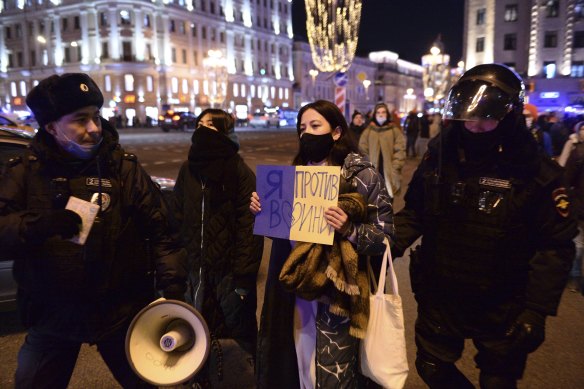 Police officers detain a demonstrator with a poster that reads: “I’m against the war”, in Moscow, Russia.