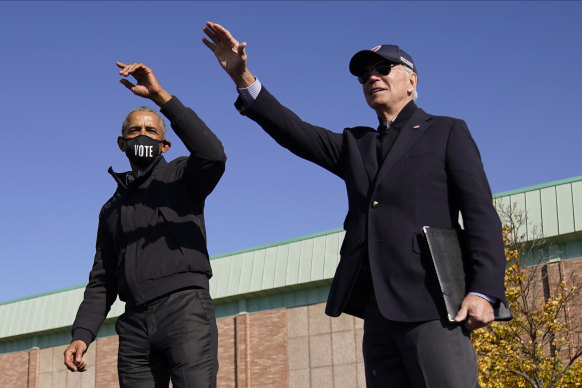 Former US President Barack Obama and then Democratic presidential nominee Joe Biden speak at a rally in Flint, Michigan.