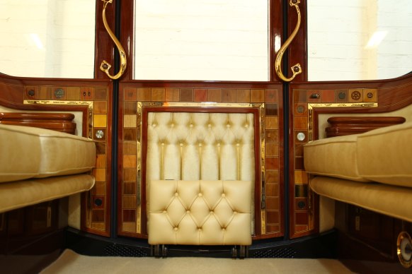 Inlaid timber segments inside the coach upholstered in primrose yellow silk and hide.