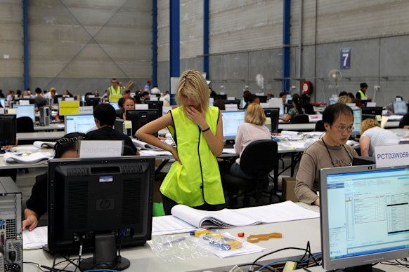 NSW Electoral Commission staff collate and count votes for the NSW upper house in 2011.