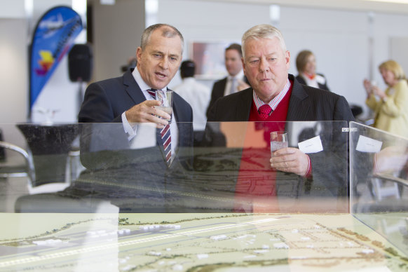 Wagners chairman John Wagner and QantasLink CEO John Gissing look at a model of the new Brisbane West Wellcamp Airport.