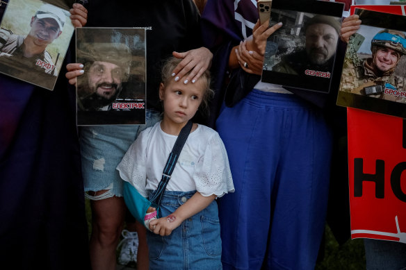 People take part in a ceremony for Ukrainian prisoners of war who defended the Azovstal Iron and Steel Works in Mariupol and were killed in a prison in Olenivka, outside Donetsk, one year ago, Ukraine.