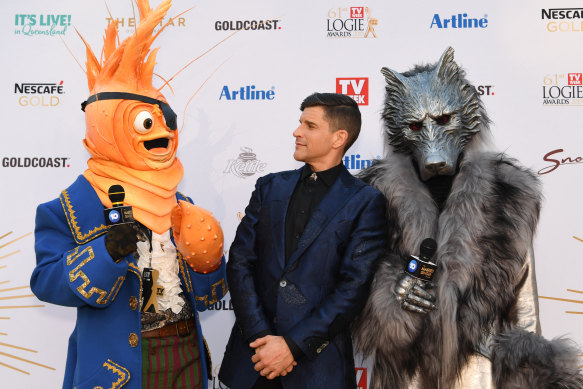 Host Osher Gunsberg with Masked Singer characters at the Logies in June. 