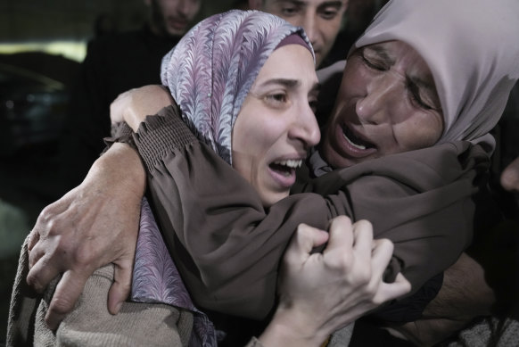 Shuruq Dwayat (left), a Palestinian prisoner released by Israel, is hugged by relatives as she arrives home in the east Jerusalem neighborhood of Sur Bahar early on Sunday.