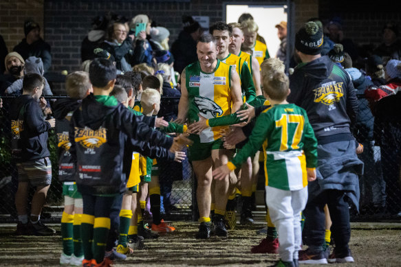 Children form a guard of honour as the Eynesbury Eagles run onto the ground on Friday evening.
