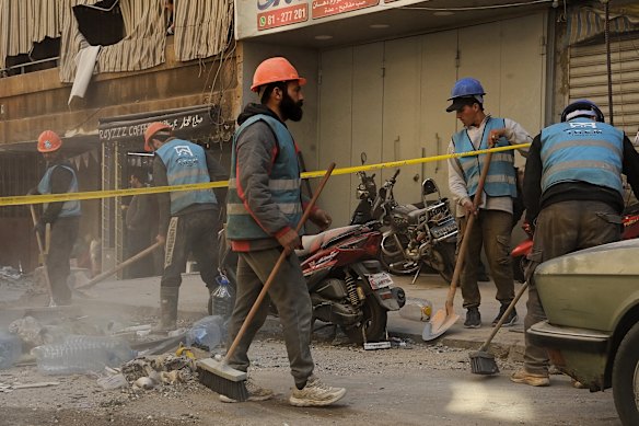 Emergency services sweep debris at an apartment building in the Aisha Bakkar area in central Beirut that was hit by an Israeli airstrike overnight. Beirut, Lebanon.